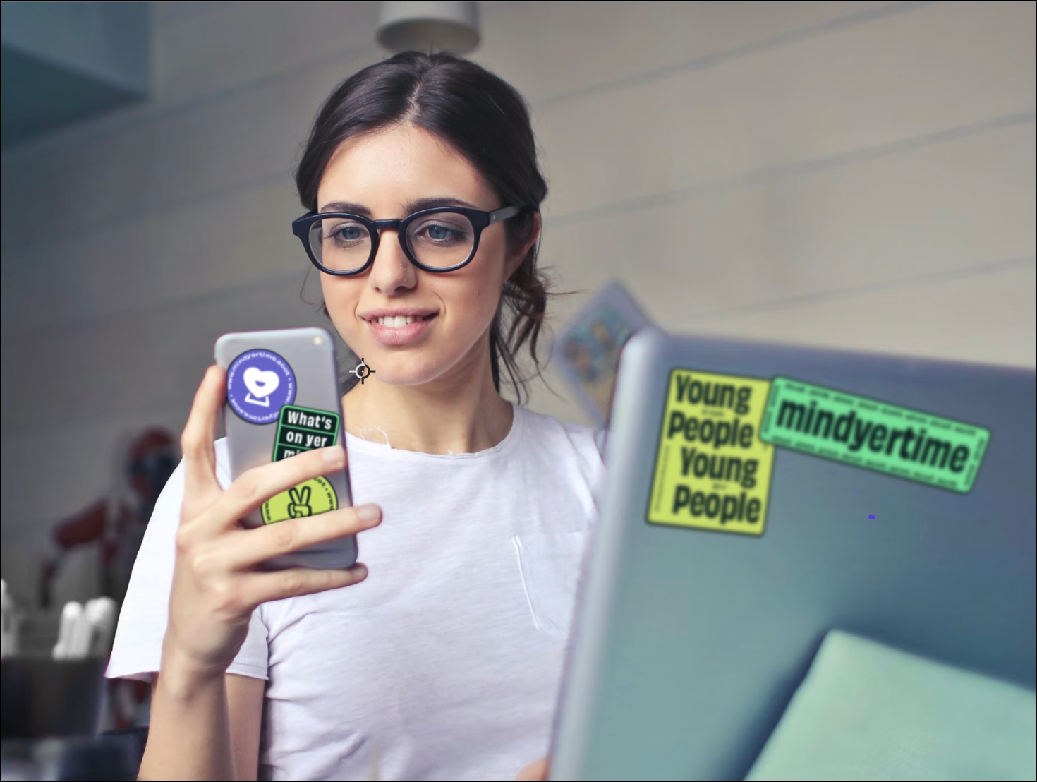 A young person looks at their mobile