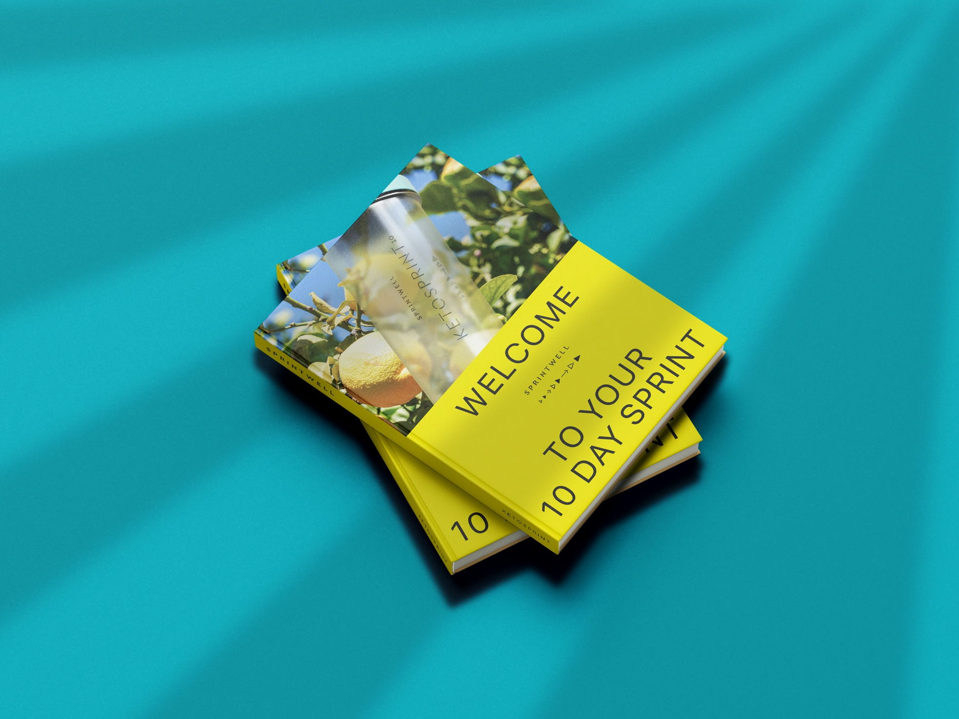 Two books sit on a teal background. The book's title “Welcome to your 10 day sprint” sits on a yellow background under a picture of a Sprintwell Ketosprint Keto protein shaker in front of a lemon tree.