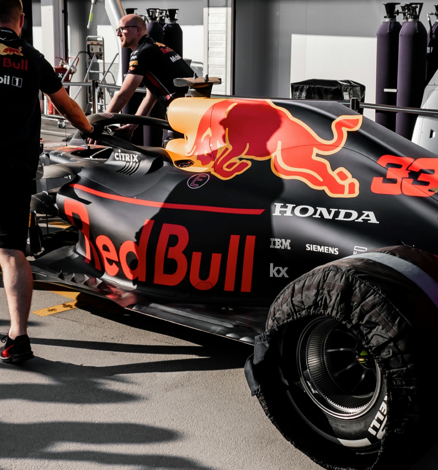 A Red Bull racing car and a member of the Red Bull team